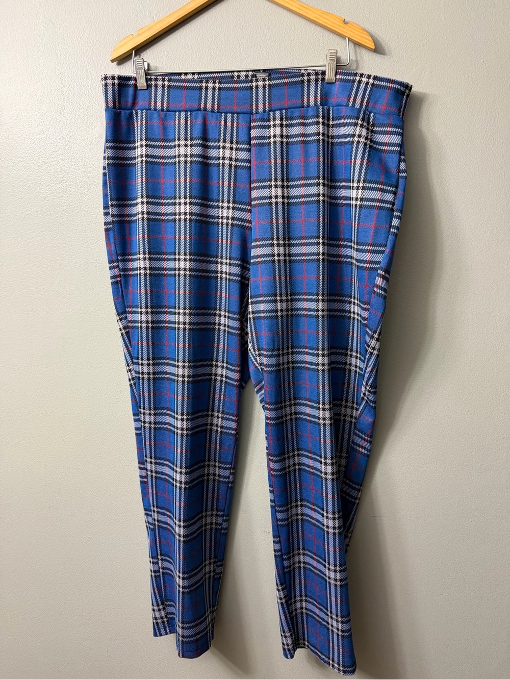 Ashley Stewart blue pull-on pants with a bold red, black, and white plaid tartan